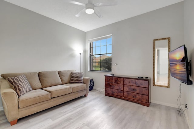 living room featuring light hardwood / wood-style floors and ceiling fan