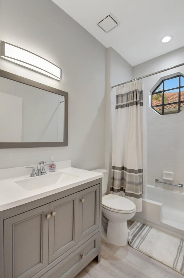 full bathroom with vanity, toilet, and shower / bathtub combination with curtain