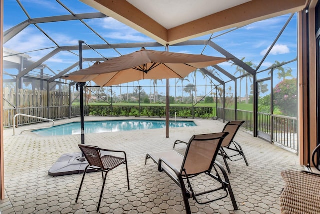 view of swimming pool featuring a patio area and a lanai