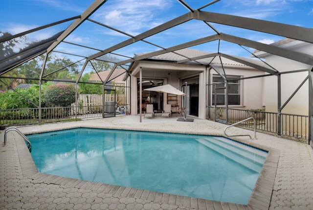 view of pool with a patio and glass enclosure