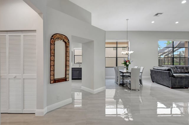 unfurnished dining area with sink and an inviting chandelier