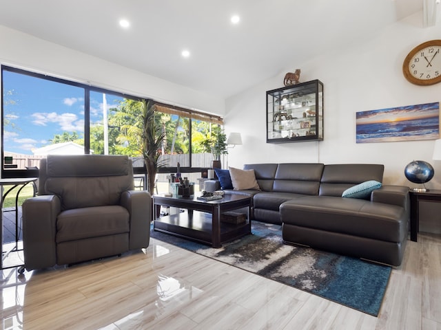 living room with lofted ceiling and light hardwood / wood-style flooring