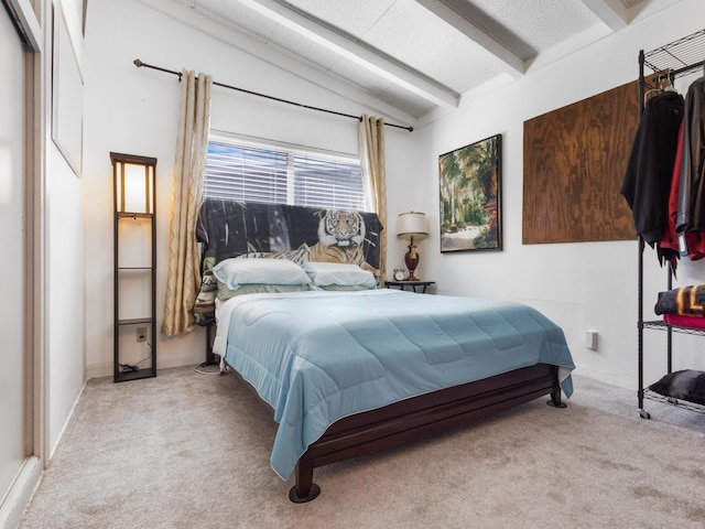 bedroom with vaulted ceiling with beams and light carpet