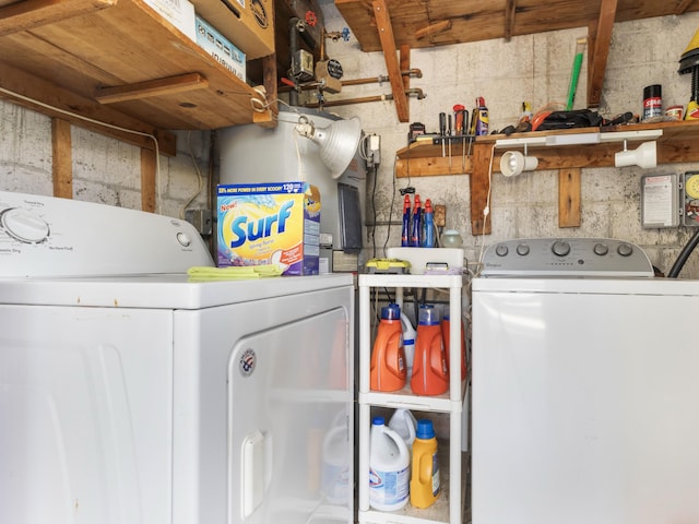 laundry area featuring water heater and washer and dryer