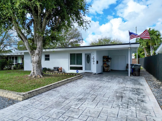 ranch-style house with a front lawn and a carport