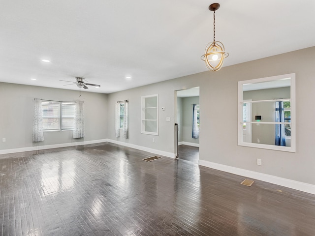 empty room featuring dark hardwood / wood-style floors and ceiling fan