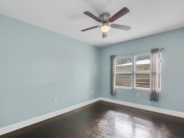 empty room with dark hardwood / wood-style floors and ceiling fan