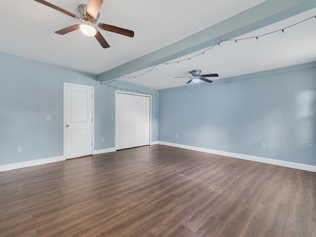 empty room with dark hardwood / wood-style flooring