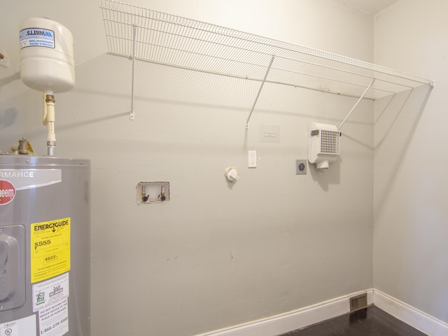 washroom featuring hookup for an electric dryer, hookup for a washing machine, and water heater