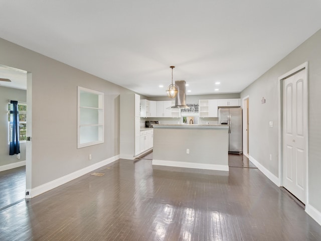 kitchen featuring white cabinetry, a kitchen island, pendant lighting, and stainless steel refrigerator with ice dispenser