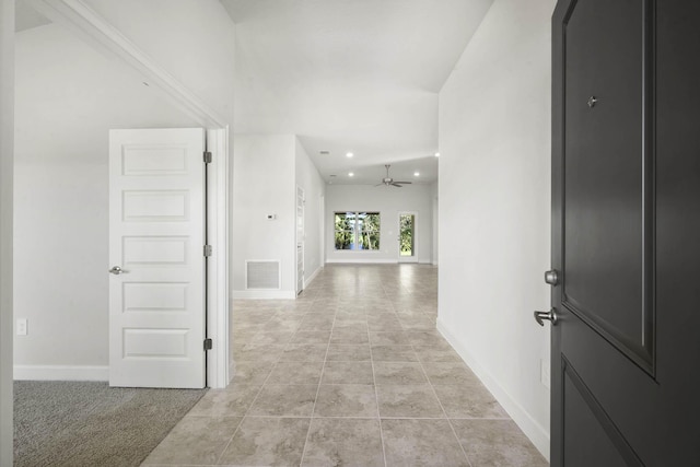 hallway featuring light carpet