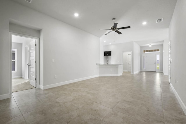 unfurnished living room featuring light tile patterned floors and ceiling fan