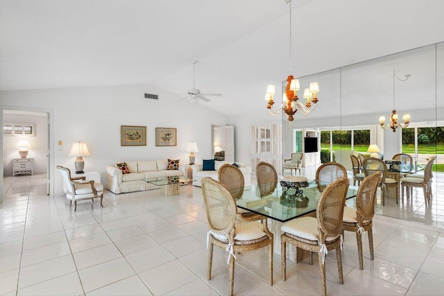 dining space with ceiling fan with notable chandelier, lofted ceiling, and light tile patterned floors