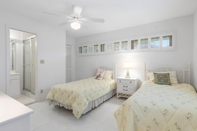 tiled bedroom featuring ceiling fan, connected bathroom, and a closet