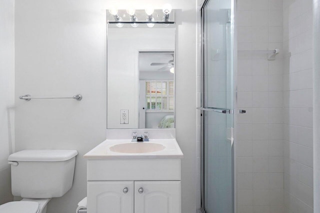 bathroom featuring ceiling fan, vanity, an enclosed shower, and toilet