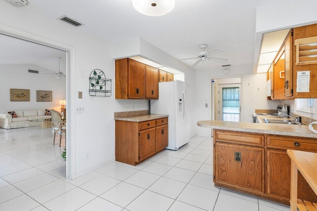 kitchen with kitchen peninsula, white appliances, ceiling fan, and light tile patterned flooring