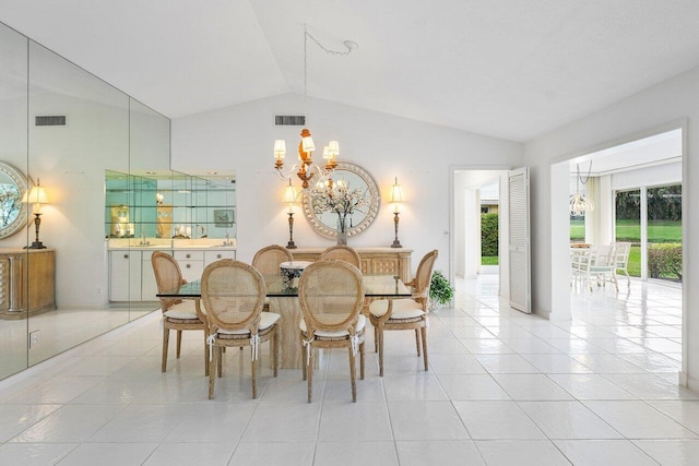 dining space featuring a notable chandelier, light tile patterned flooring, and lofted ceiling