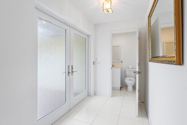 bathroom with tile patterned flooring, vanity, and toilet