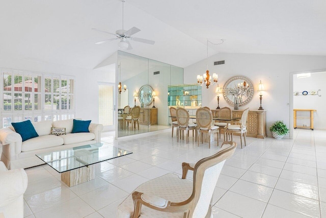 tiled living room with ceiling fan with notable chandelier and high vaulted ceiling