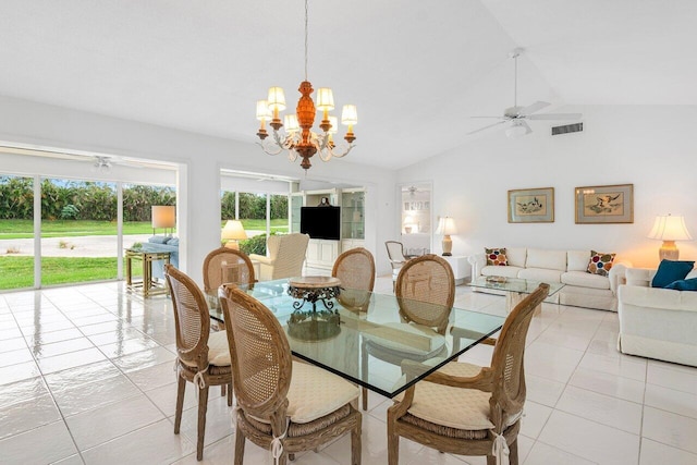 tiled dining area with ceiling fan with notable chandelier and vaulted ceiling