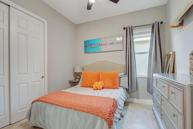 bedroom with ceiling fan and a closet