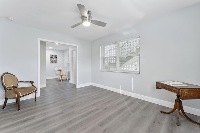 living area with ceiling fan and light wood-type flooring