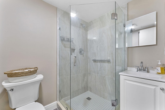 bathroom with toilet, a shower with door, and vanity