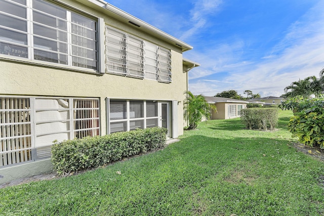 view of side of property with a yard