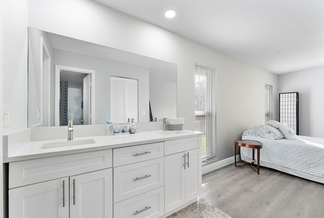 bathroom with hardwood / wood-style floors and vanity