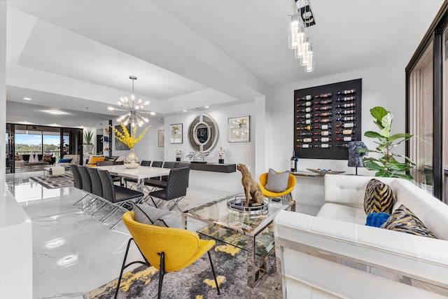 living room featuring a raised ceiling and a notable chandelier