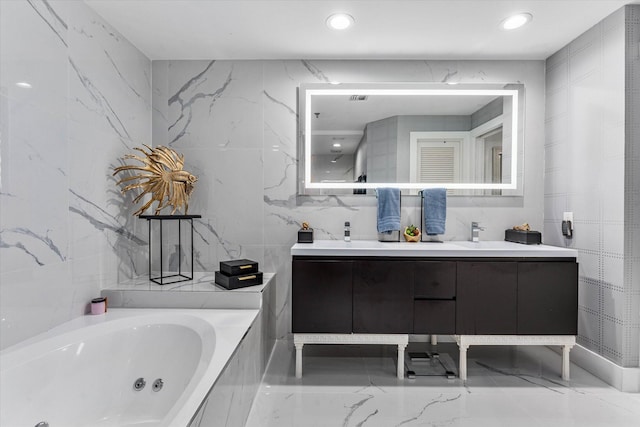 bathroom with vanity and a relaxing tiled tub