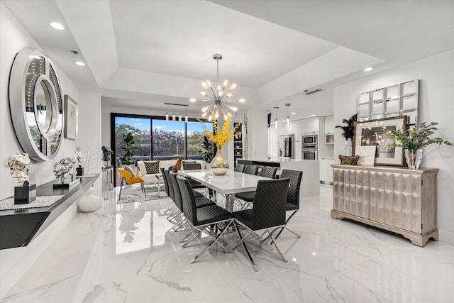 dining space featuring a tray ceiling and an inviting chandelier