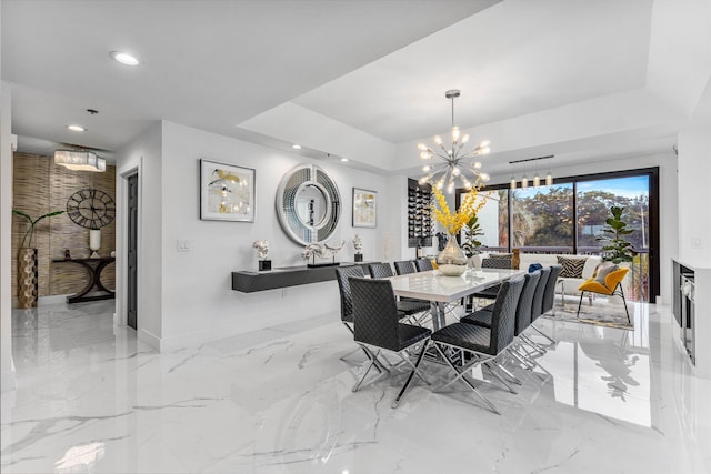 dining room featuring a tray ceiling and a chandelier