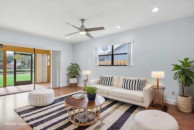 living room with hardwood / wood-style floors and ceiling fan