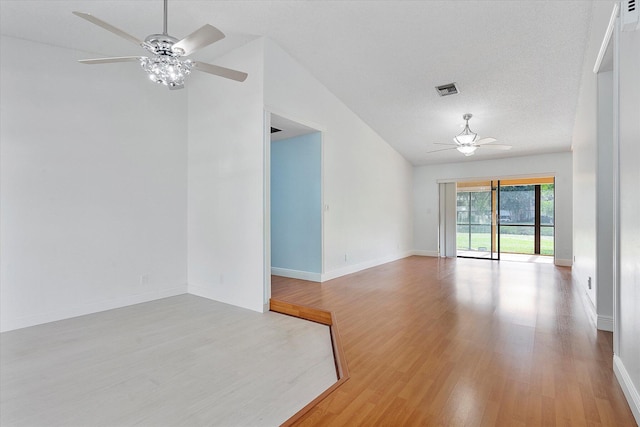 spare room with a textured ceiling, light wood-type flooring, ceiling fan, and lofted ceiling