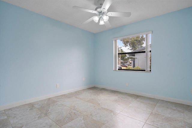 spare room with ceiling fan