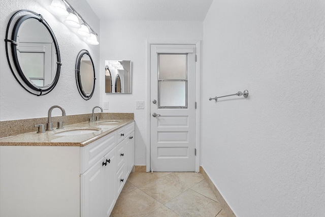 bathroom with tile patterned floors and vanity