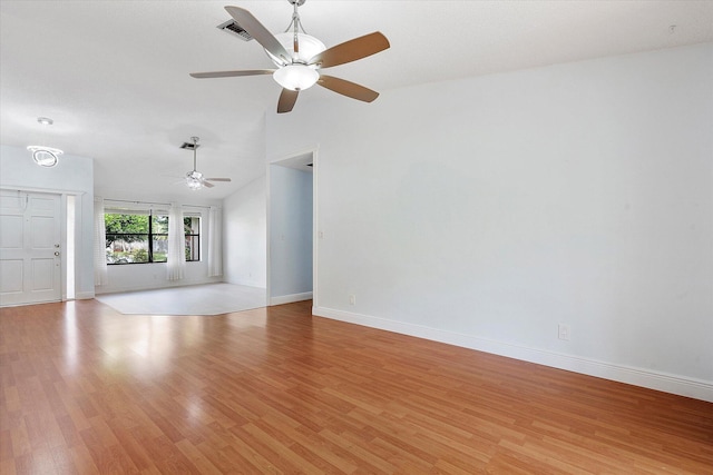 unfurnished living room featuring ceiling fan, vaulted ceiling, and light wood-type flooring