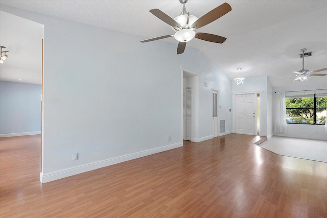 unfurnished living room featuring light wood-type flooring, ceiling fan, and lofted ceiling