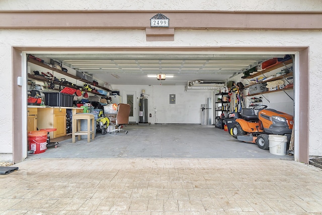 garage with electric water heater, electric panel, and a garage door opener