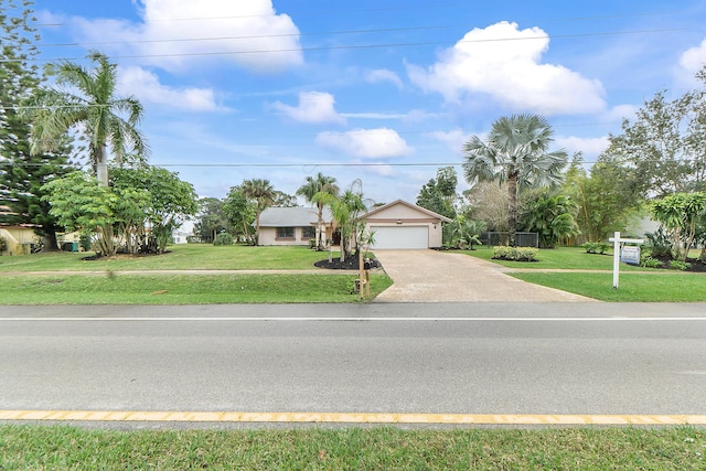 view of front of house with a garage and a front yard