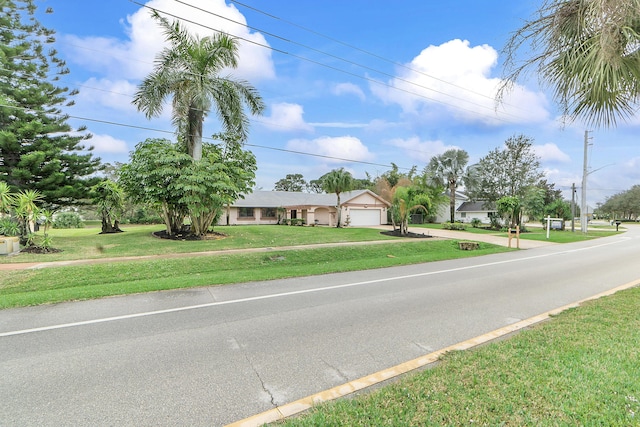 view of front of property with a garage and a front lawn