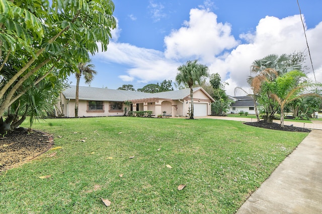 single story home featuring a garage and a front yard