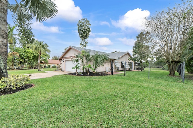 view of front of property featuring a garage and a front lawn