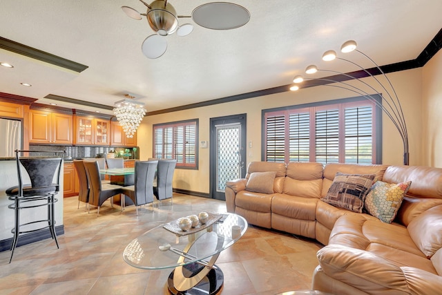 living room featuring an inviting chandelier and ornamental molding