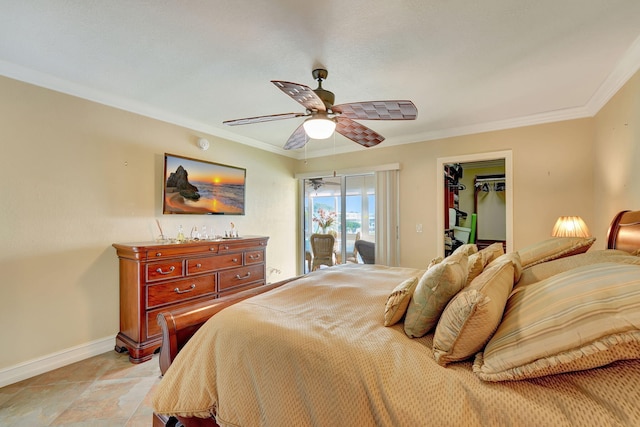 bedroom featuring a closet, ceiling fan, crown molding, and a spacious closet