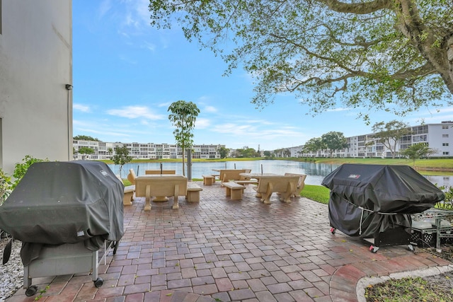 view of patio / terrace featuring a water view and grilling area