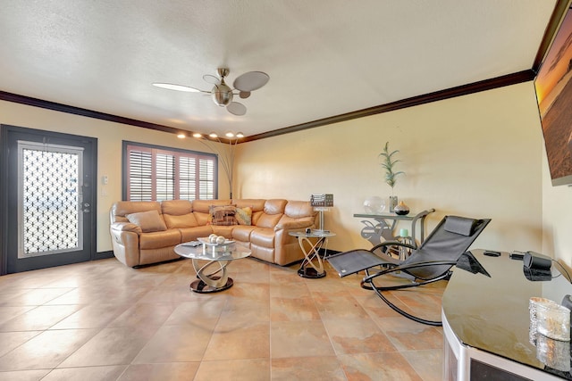 living room with ceiling fan, light tile patterned flooring, a textured ceiling, and ornamental molding