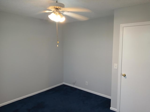 spare room with ceiling fan and carpet