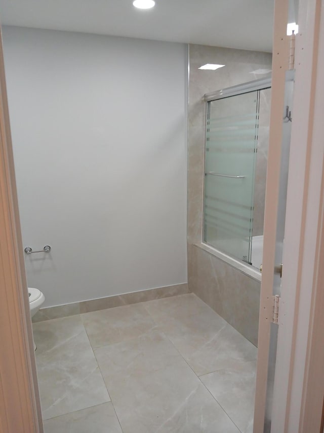 bathroom with toilet, bathtub / shower combination, and tile patterned floors